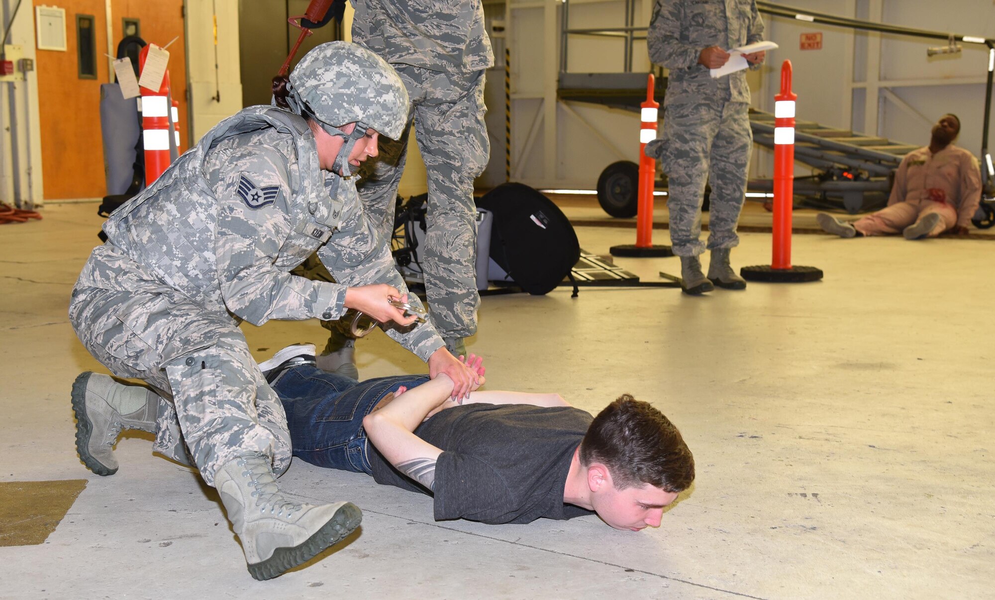 Staff Sgt. Hali Klein, 45th Security Forces Squadron, apprehends a suspect during a joint 920th Rescue Wing and 45th Space Wing active shooter exercise July 25, 2017 in Hangar 750. During the scenario, four Airmen were wounded and three Airmen were killed by a military assailant. The security forces team was the first to respond to the scene, followed by a team of 308th Rescue Squadron pararesceumen and 45th Civil Engineer Squadron firefighters. (U.S. Air Force photo/Tech. Sgt. Lindsey Maurice)