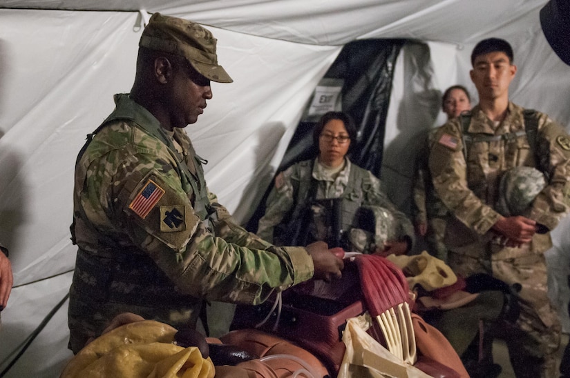 U.S. Army Reserve Sgt. 1st Class Terry Warren, of the Effects and Enablers Team augmenting the 84th Training Command Combat Support Training Exercise and the Army Medical Command’s Global Medic Exercise headquartered out of Fort Hunter Liggett, California, demonstrates a “cut suit.” This surgical suit is meant to replicate realistic scenarios for medical professionals to train on during mass casualty exercises on Camp Roberts, California, July 16, 2017. (U.S. Army Reserve Photo by Spc. Ce Shi, 222nd Broadcast Public Affairs Detachment)