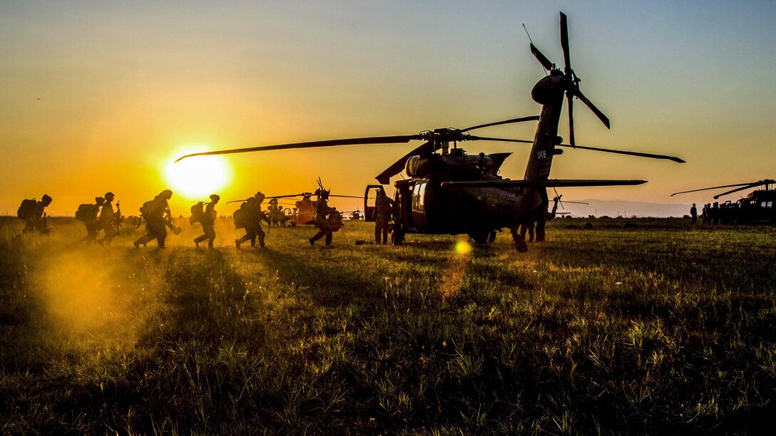 Soldiers practice loading into a UH-60 Black Hawk helicopter at Bezmer Air Base, Bulgaria, on July 21. The soldiers, assigned to the 173rd Airborne Brigade, prepped for Swift Response, an all-night air assault mission, during Saber Guardian 17 in the Black Sea region. Army photo by Spc. Thomas Scaggs