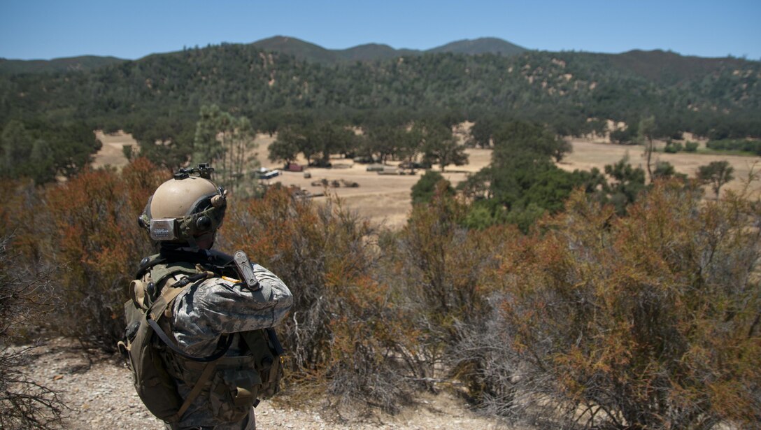 Sgt. Shawn Crampes, a noncommissioned officer with the 718th Engineer Company,
watches the main approaches to his company's motor pool and command post while
stationed on a nearby hill on July 19, 2017, at Fort Hunter Liggett, Calif. The observation post was part of the company's security plan to allow them to safely build and improve their base of operations while under threat of simulated attack. Nearly 5,400 service members from the U.S. Army Reserve Command, U.S. Army, Army National Guard, U.S. Navy, and Canadian Armed Forces are training at Fort Hunter Liggett as part of the 84th Training Command’s CSTX 91-17- 03 and ARMEDCOM’s Global Medic; this is a unique training opportunity that allows U.S. Army Reserve units to train alongside their multi-component and joint partners as part of the America’s Army Reserve evolution into the most lethal Federal Reserve force in the history of the nation. (U.S. Army Reserve photo by Sgt. David L. Nye, 301st Public Affairs Detachment)