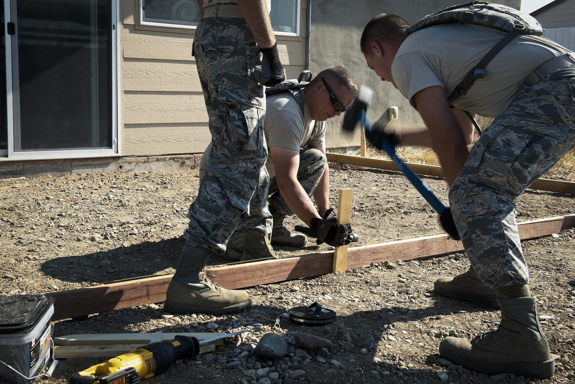 Pavement and construction equipment specialists with the 182nd Civil Engineer Squadron, Illinois Air National Guard, build a concrete form during annual training in Crow Agency, Mont., July 24, 2017. The squadron helped build homes for Native American veterans as part of the Department of Defense’s Innovative Readiness Training civil-military relations program. (U.S. Air National Guard photo by Tech. Sgt. Lealan Buehrer)