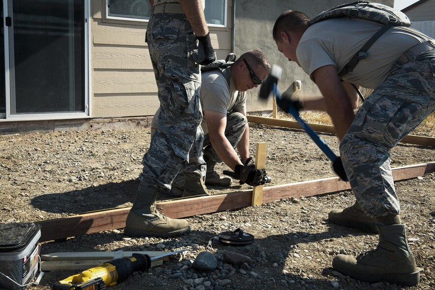 Pavement and construction equipment specialists with the 182nd Civil Engineer Squadron, Illinois Air National Guard, build a concrete form during annual training in Crow Agency, Mont., July 24, 2017. The squadron helped build homes for Native American veterans as part of the Department of Defense’s Innovative Readiness Training civil-military relations program. (U.S. Air National Guard photo/Tech. Sgt. Lealan Buehrer)