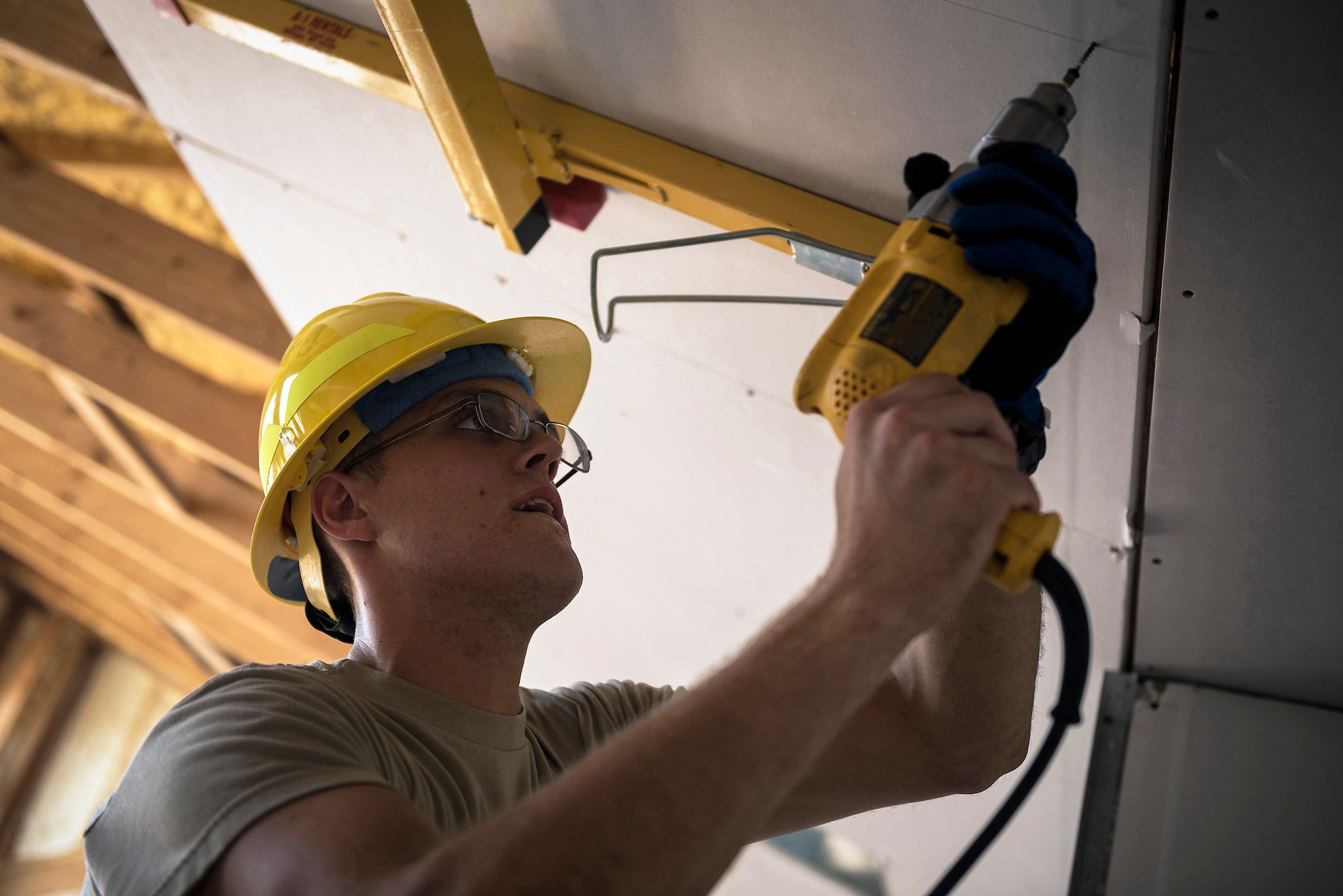 U.S. Air Force Staff Sgt. Daniel Kern, an electrical power production specialist with the 182nd Civil Engineer Squadron, Illinois Air National Guard, attaches drywall to the ceiling during annual training in Crow Agency, Mont., July 24, 2017. The squadron helped build homes for Native American veterans as part of the Department of Defense’s Innovative Readiness Training civil-military relations program. (U.S. Air National Guard photo by Tech. Sgt. Lealan Buehrer)