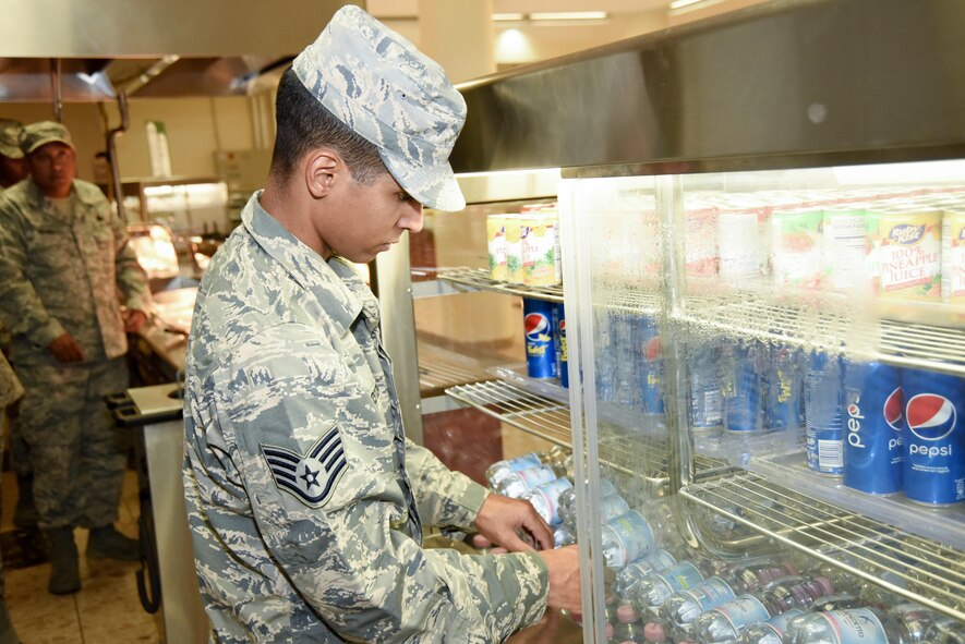 AVIANO AIR BASE, Italy -- Staff Sgt. Angel Agosto, 301st Fighter Wing Force Support Squadron food service journeyman, stocks the beverage area prior to the lunch rush at La Dulce Vida Dining Facility in Aviano Air Base, Italy. Ten 301st FSS Airmen fulfilled their annual training requirement here while training on various stations. They also worked breakfast, lunch and dinner shifts, which included serving over 700 meals daily. (U.S. Air Force photo by Tech. Sgt. Jeremy Roman)