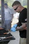 FORT EUSTIS, Va. – Chief Damage Controlman Benjamin Allen, CBRN analyst, Joint Task force Civil Support grills during the JTF-CS Family Day picnic, July 21, 2017. JTF-CS provides command and control for designated Department of Defense specialized response forces to assist local, state, federal and tribal partners in saving lives, preventing further injury, and providing critical support to enable community recovery. (Official DOD Photo by MC2 Benjamin Liston/RELEASED)