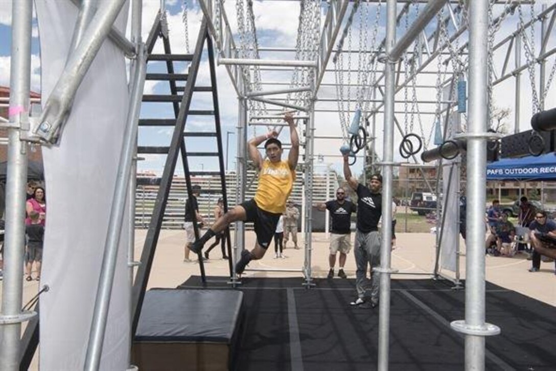Force Support Squadron fitness specialist, negotiates his way through the Alpha Warrior Battle Rig at Peterson Air Force Base, Colo., on May 12, 2017. The Battle Rig is designed for functional fitness and fulfills the four pillars of fitness, physical, mental, social and spiritual.
