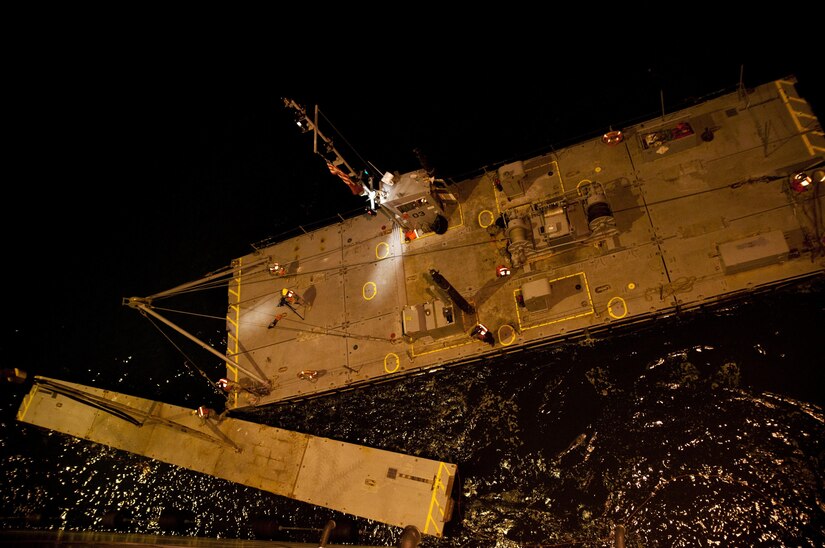 A string for a roll-on/roll-off discharge facility is moved by a modular warping tug after being lowered into the water by a crane of the USNS Bob Hope during training at the Port of San Diego on July 16, 2017, in support of a U.S. Army Reserve Command effort to construct a causeway and rapidly move warfighting supplies across it during Exercise Big LOTS West, a joint military training exercise designed to reinforce the 1394th Transportation Brigade's ability to rapidly deploy vital combat equipment to an operational environment. (Photo by U.S. Army Reserve Sgt. David L. Nye, 301st Public Affairs Detachment)