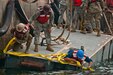 U.S. Army watercraft operators and engineers assemble a roll-on/roll-off discharge facility during training at the Port of San Diego on July 16, 2017. The RRDF is a causeway is used to quickly move supplies from ships to shore. U.S. Army Reserve Command Soldiers are participating in Exercise Big LOTS West, a joint military training exercise designed to reinforce the 1394th Transportation Brigade's ability to rapidly deploy vital combat equipment to an operational environment. (Photo by U.S. Army Reserve Sgt. David L. Nye, 301st Public Affairs Detachment)