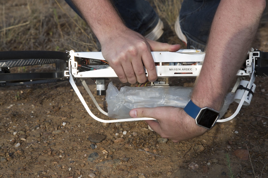 An IV-solution bag equipped with a metal plate is loaded on a Joint Tactical Aerial Resupply Vehicle (JTARV) for transport from a simulated forward operating base to a Marine Special Operations Company in the field aboard Marine Corps Base Camp Pendleton, Calif., July 7, 2017. The JTARV, which is in the developmental phase, is a lightweight autonomous vehicle that provides an aerial resupply capability for immediate support to operational units. It was being tested as a resupply platform for machine-gun sustainment training with a cargo unmanned logistics system (C-ULS) during a tactical readiness exercise (TRX).