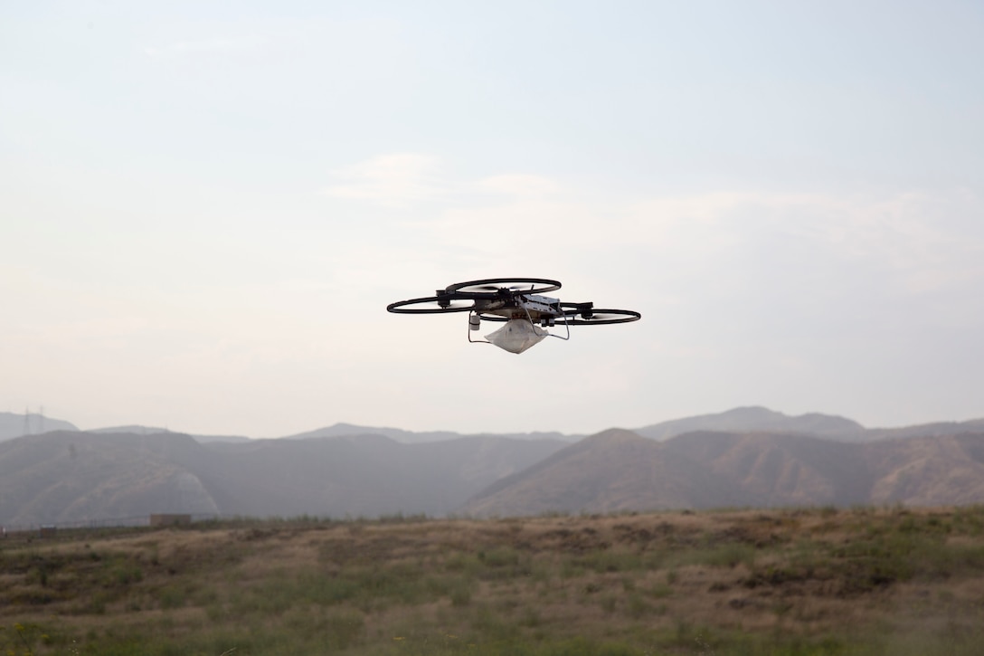 An IV-solution bag attached by a metal plate is carried by a Joint Tactical Aerial Resupply Vehicle (JTARV) for transport from a simulated forward operating base to a Marine Special Operations Company in the field aboard Marine Corps Base Camp Pendleton, Calif., July 7, 2017. The JTARV, which is in the developmental phase, is a lightweight autonomous vehicle that provides an aerial resupply capability for immediate support to operational units. It was being tested as a resupply platform for machine-gun sustainment training with a cargo unmanned logistics system (C-ULS) during a tactical readiness exercise (TRX).