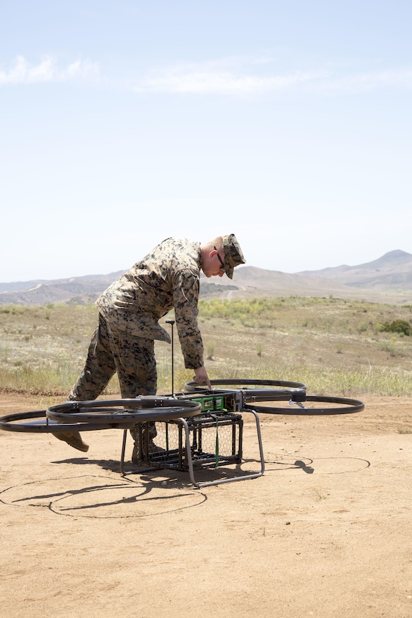 A UAV pilot with 1st Marine Raider Support Battalion, U.S. Marine Corps Forces, Special Operations Command, preps the Joint Tactical Aerial Resupply Vehicle (JTARV) for transport from a simulated forward operating base to a Marine Special Operations Company in the field aboard Marine Corps Base Camp Pendleton, Calif., July 7, 2017. The unit conducted machine-gun sustainment training with a cargo unmanned logistics system (C-ULS) during a tactical readiness exercise (TRX) aboard Marine Corps Base Camp Pendleton, Calif., July 6-11, 2017.