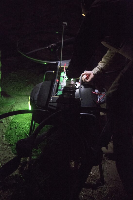 A critical skills operator with 1st Marine Raider Support Battalion, U.S. Marine Corps Forces, Special Operations Command, places the Joint Tactical Aerial Resupply Vehicle (JTARV) at a launch site prior to take off aboard Marine Corps Base Camp Pendleton, Calif., July 11. The JTARV, which is in the developmental phase, is a lightweight autonomous vehicle which provides an aerial resupply capability for immediate support to operational units. It was being tested as a resupply platform for machine-gun sustainment training with a cargo unmanned logistics system (C-ULS) during their TRX.