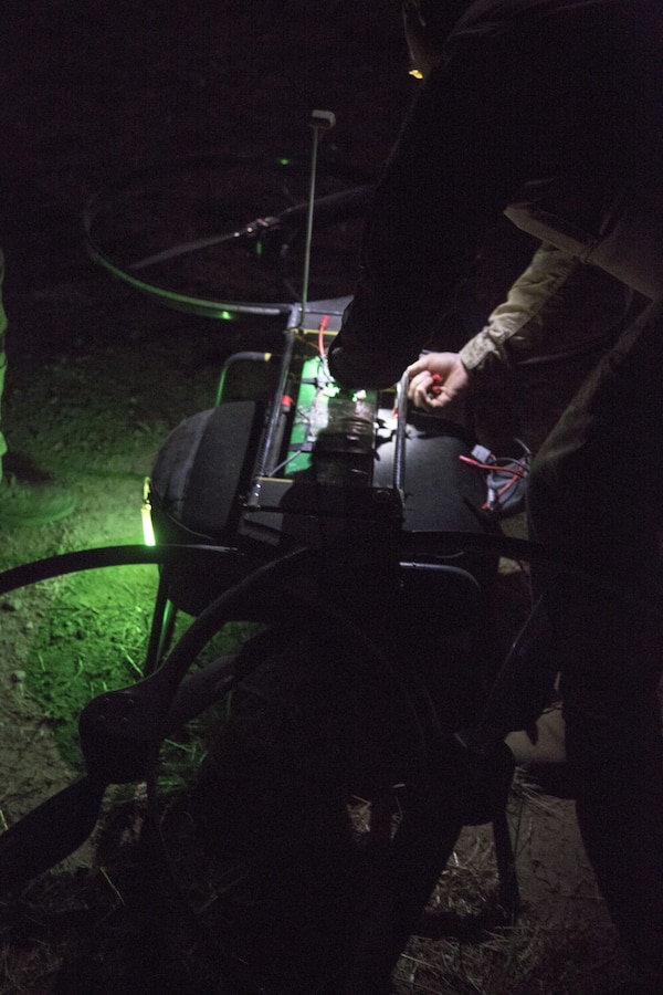A critical skills operator with 1st Marine Raider Support Battalion, U.S. Marine Corps Forces, Special Operations Command, places the Joint Tactical Aerial Resupply Vehicle (JTARV) at a launch site prior to take off aboard Marine Corps Base Camp Pendleton, Calif., July 11. The JTARV, which is in the developmental phase, is a lightweight autonomous vehicle which provides an aerial resupply capability for immediate support to operational units. It was being tested as a resupply platform for machine-gun sustainment training with a cargo unmanned logistics system (C-ULS) during their TRX.