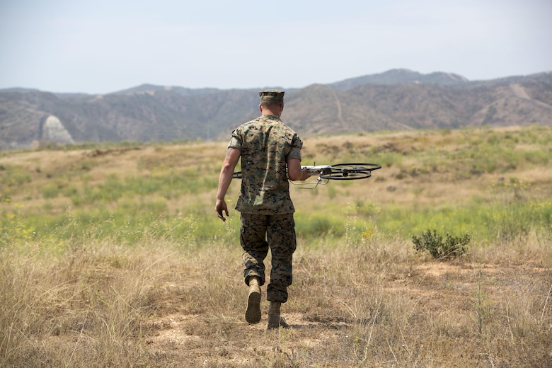 A critical skills operator with 1st Marine Raider Support Battalion, U.S. Marine Corps Forces, Special Operations Command, places the Joint Tactical Aerial Resupply Vehicle (JTARV) at a launch site prior to take off aboard Marine Corps Base Camp Pendleton, Calif., July 7, 2017. The JTARV, which is in the developmental phase, is a lightweight autonomous vehicle which provides an aerial resupply capability for immediate support to operational units. It was being tested as a resupply platform for machine-gun sustainment training with a cargo unmanned logistics system (C-ULS) during a tactical readiness exercise (TRX).