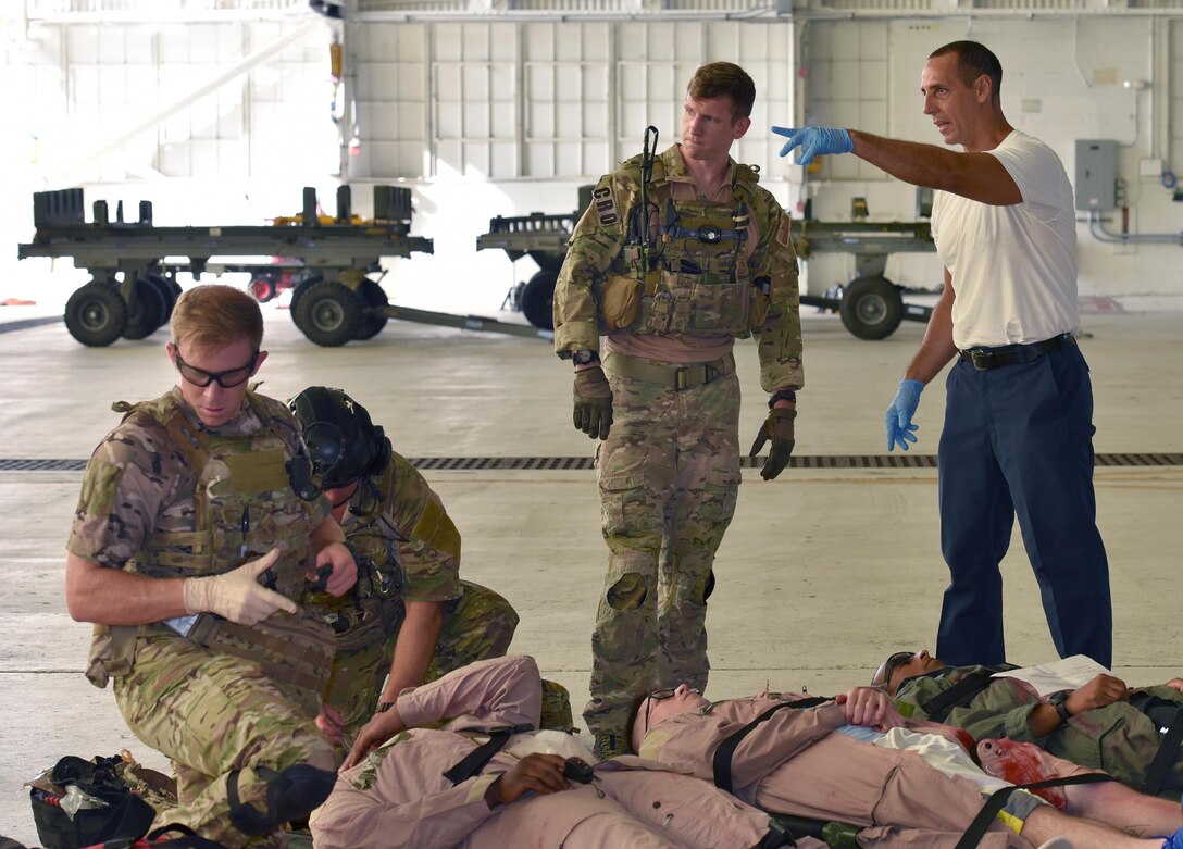 Matthew Martines, right, 45th Civil Engineer Squadron firefighter, and 1st Lt. Ryan Kelly, 38th Rescue Squadron combat rescue officer, work through the logistics of gathering active shooter exercise victims for transport to the hospital July 25, 2017 in Hangar 750. The installation firefighters and 308th Rescue Squadron pararescuemen worked closely at the scene of the crime to ensure the victims were cared for and safely transported to the hospital. Kelly is on temporary duty with the 308th RQS from Moody Air Force Base, Georgia. The exercise was a joint endeavor between the host 45th Space Wing and 920th Rescue Wing. (U.S. Air Force photo/Tech. Sgt. Lindsey Maurice)