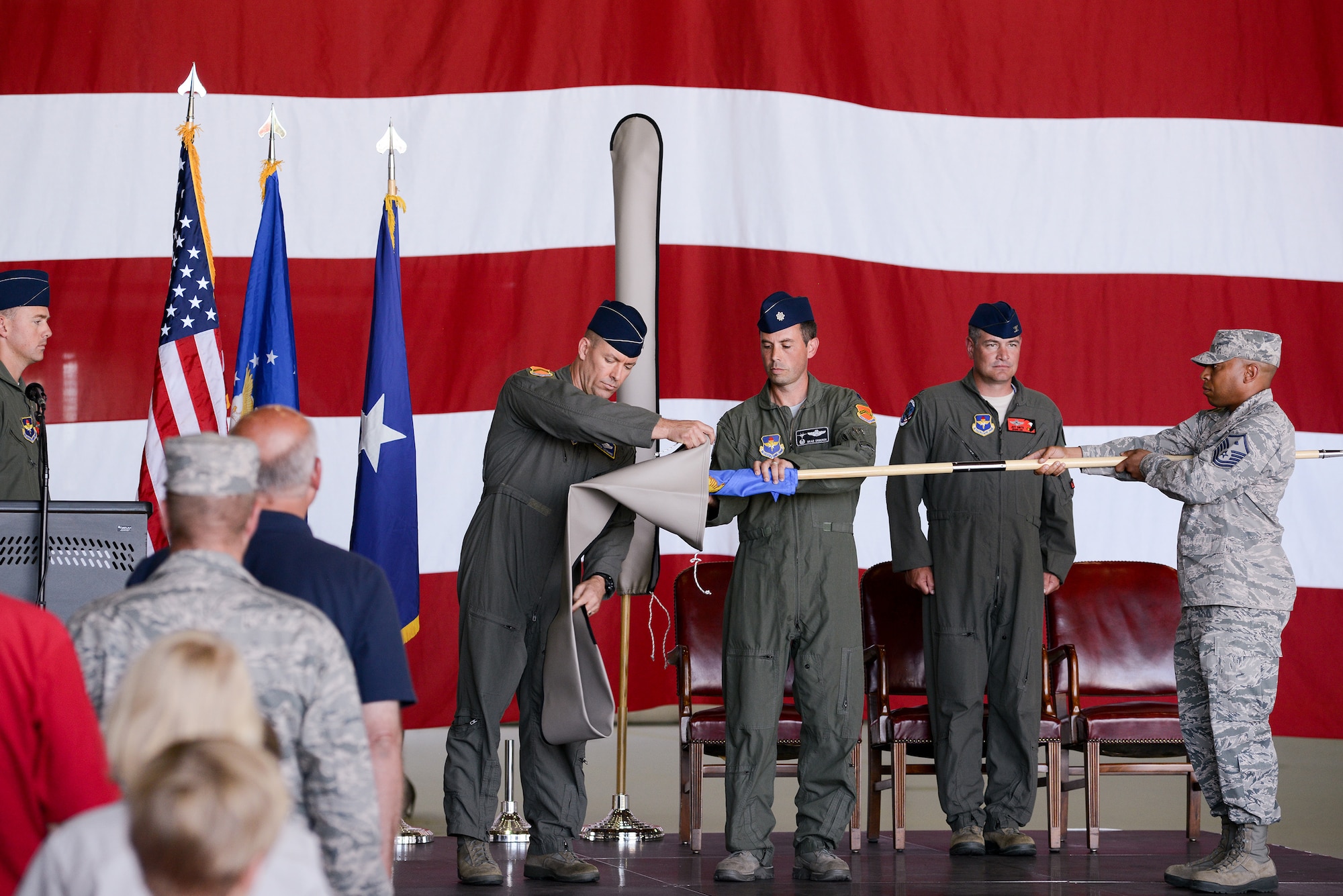 U.S. Air Force members from the 173rd Fighter Wing and 550th Fighter Squadron stand at attention as the Detachment 2 flag is rolled up and covered during an activation ceremony, July 21, 2017, at Kingsley Field in Klamath Falls, Oregon. The active duty Air Force detachment based out of the Kingsley Field, previously Detachment 2, is now officially designated as the 550th Fighter Squadron. 550th Fighter Squadron members will continue to fall under the command of the 56th Operations Group at Luke Air Force Base, Arizona. (U.S. Air National Guard photo by Staff Sgt. Penny Snoozy)