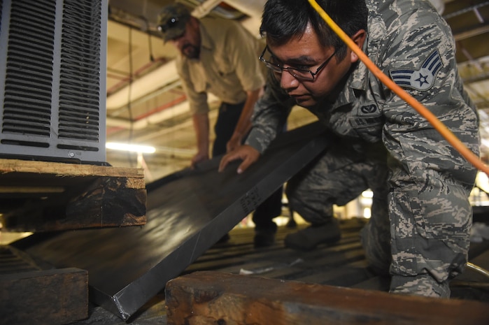 Senior Airman Daniel Monzon, 628th Civil Engineer Squadron heating, ventilation and air conditioning technician, helps maintain an air conditioning unit inside the 437th Aerial Port Squadron building on Joint Base Charleston, S.C., July 25. 