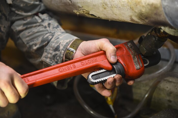 Staff Sgt. Joshua Barr, 628th Civil Engineer Squadron heating, ventilation and air conditioning technician, drains excess water from a coolant system at a dormitory building on Joint Base Charleston, S.C., July 25. HVAC is responsible for maintaining proper temperatures for some of the base’s most important systems.