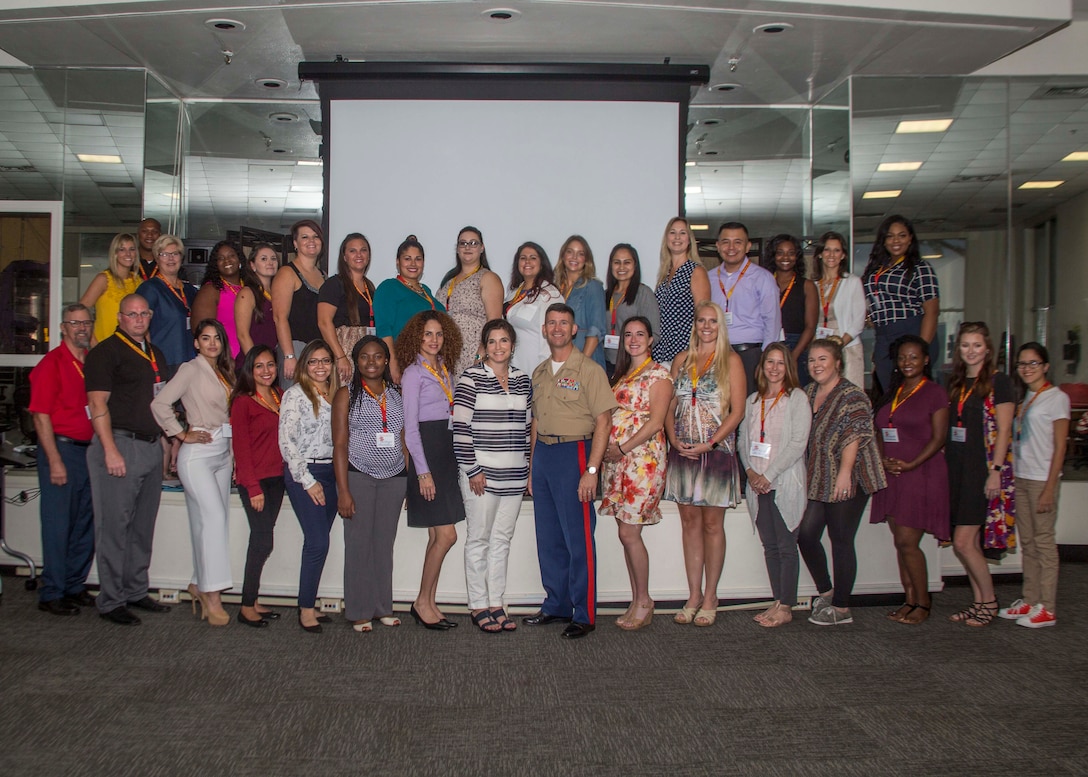 U.S. Marines and spouses with 6th Marine Corps District (6MCD) pose for a group photo during the District Spouse Orientation Course (DSOC) at the Four Winds Family Readiness Center aboard Marine Corps Recruit Depot Parris Island, South Carolina, July 26, 2017.  The DSOC provided Marines and their spouses a broad spectrum of tools to help them transition into the Marine Corps’ recruiting field. The spouses came from across the District to build connections and network with fellow spouses.  (U.S. Marine Corps photo by Lance Cpl. Jack A. E. Rigsby)