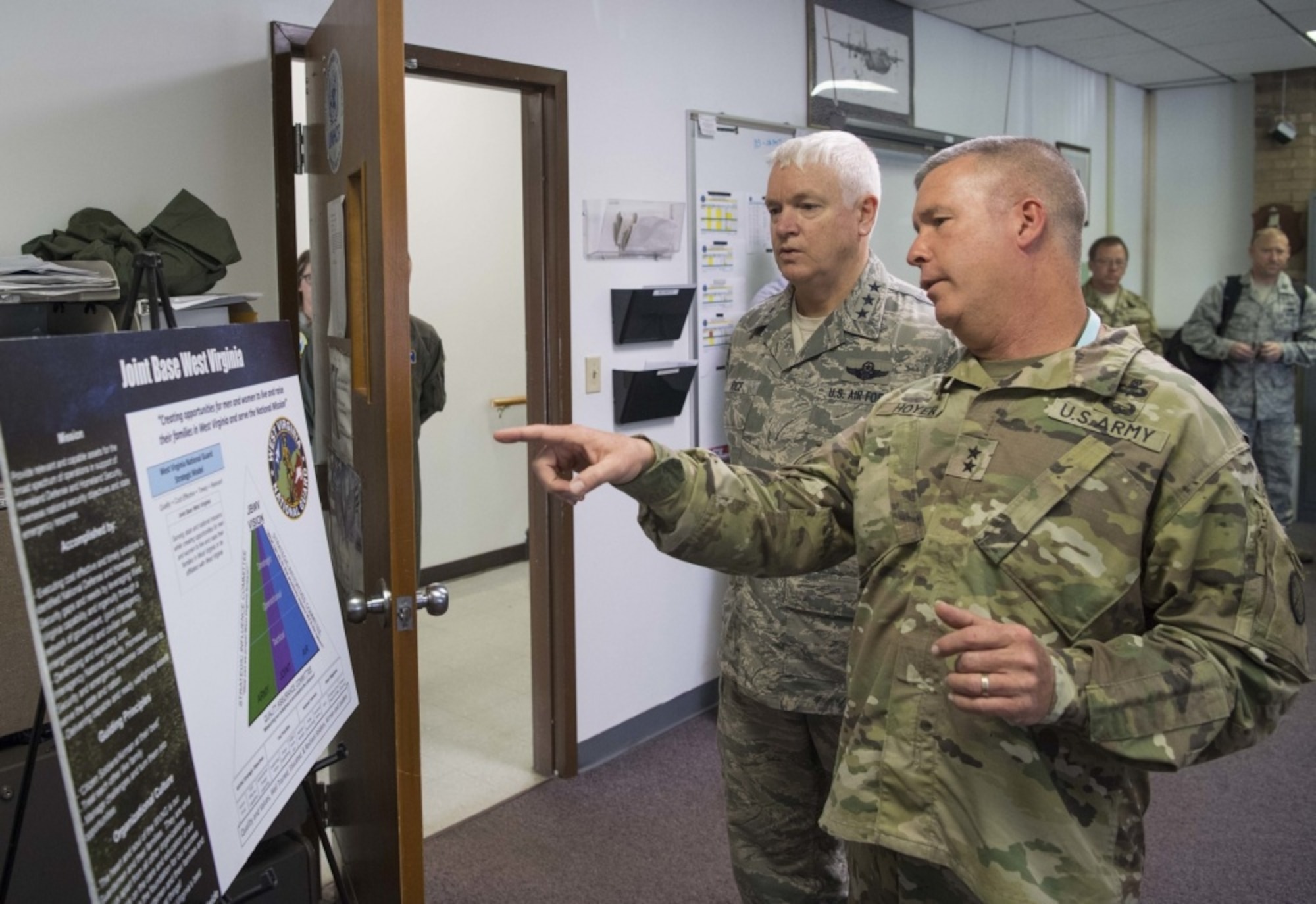 Maj. Gen. James A. Hoyer, the Adjutant General of the West Virginia National Guard, discusses the structure of Joint Base West Virginia with Director of the Air National Guard, Lt. Gen. L. Scott Rice, during a visit to McLaughlin Air National Guard Base July 26, 2017. Rice and Air National Guard Command Chief Master Sgt. Ronald Anderson gained insight into the 130th AW mission and recognized the accomplishments of some of the unit’s outstanding Airmen through a coining ceremony. (U.S. Air National Guard photo by Tech. Sgt. De-Juan Haley) 