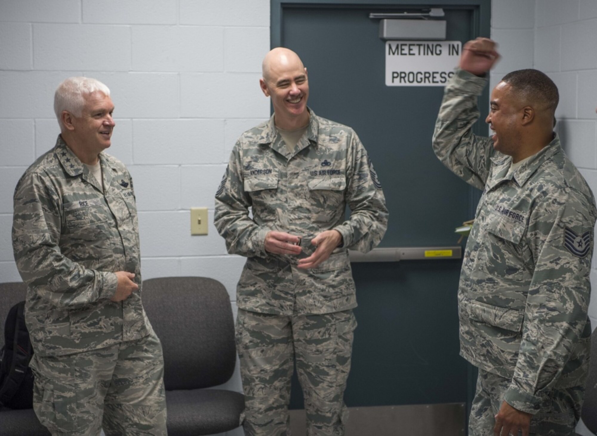 Director of the Air National Guard, Lt. Gen. L. Scott Rice, and ANG Command Chief Master Sgt. Ronald Anderson, laugh with 130th Airlift Wing recruiter, Tech. Sgt. Anthony Sherrod, during a visit to McLaughlin Air National Guard Base July 26, 2017. Sherrod was one of five Airmen to receive a challenge coin from Rice and Anderson and was lauded for being one of the state’s leading recruiters with over thirty enlistments in the fiscal year. (U.S. Air National Guard photo by Tech. Sgt. De-Juan Haley) 