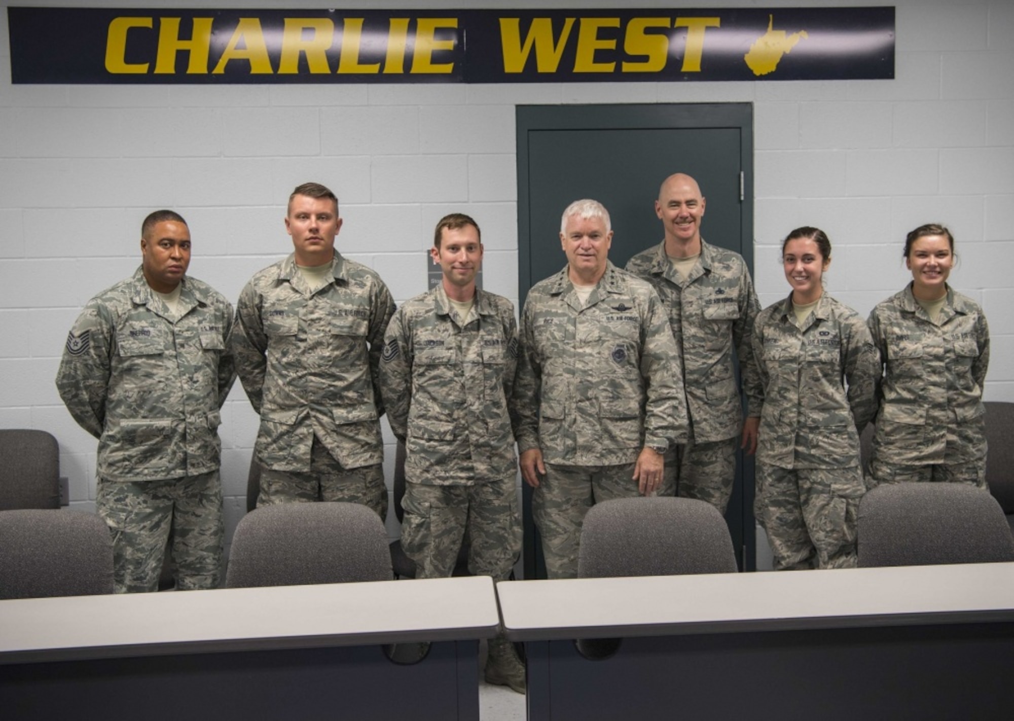 Director of the Air National Guard, Lt. Gen. L. Scott Rice, and ANG Command Chief Master Sgt. Ronald Anderson, pose with Tech. Sgt. Anthony Sherrod, Staff Sgt. Randy Downs, Tech. Sgt. Jeffery Jackson, Senior Airman Mallory Ranker, and Airman 1st Class Autumn Davis after a coining ceremony held July 26, 2017 at McLaughlin Air National Guard Base, Charleston, W.Va. Rice and Anderson recognized the outstanding accomplishments of the Airmen for their contributions to the mission and heroism off duty. (U.S. Air National Guard photo by Tech. Sgt. De-Juan Haley) 