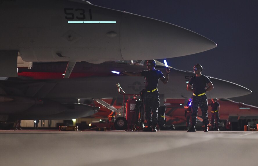Navy maintenance personnel from Electronic Attack Squadron 134, assigned to Naval Air Station Whidbey Island, Wash., conduct a preflight check on an EA-18G Growler on the flightline at Nellis Air Force Base, Nev., during Red Flag 17-3, July 14, 2017. During Red Flag 17-3, both Navy and Marine aircraft train alongside the Air Force in fast paced, advanced combat training. (U.S. Air Force photo by Senior Airman Dustin Mullen/Released)