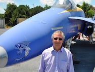 Kurt Mikoleit stands in front of an F-18 that is used as a ground plane for testing and evaluating the hazards of electromagnetic radiation to ordnance at NSWC Dahlgren 
Division’s Electromagnetic Environmental Effects test site.
