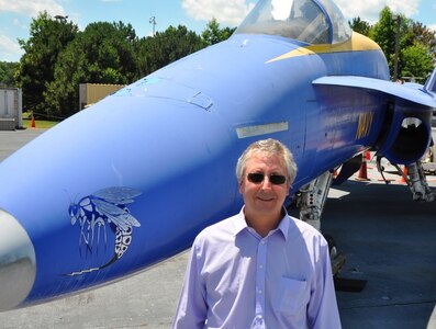 Kurt Mikoleit stands in front of an F-18 that is used as a ground plane for testing and evaluating the hazards of electromagnetic radiation to ordnance at NSWC Dahlgren 
Division’s Electromagnetic Environmental Effects test site.
