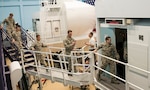 Reserve Officer Training Corps cadets enter the C-5 flight simulator at the 733rd Training Squadron, July 26, 2017 at Joint Base San Antonio-Lackland. The cadets also visited the 433rd Maintenance Squadron's engine shop and received a C-5M Super Galaxy aircraft tour. (U.S. Air Force photo by Benjamin Faske)