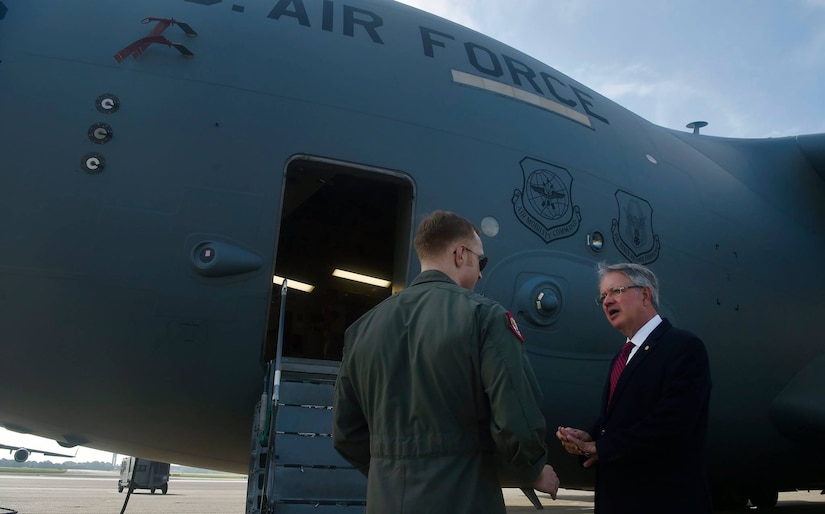 Charleston Mayor John Tecklenburg, right, talks to Australian Royal air force Flt. Lt. Timothy Burnard, left, C-17 Globemaster III pilot, during a tour of a C-17 as part of a site visit here, July 25. The locations Tecklenburg toured included the Naval Health Clinic Charleston, the Naval Nuclear Power Training Command and the 841st Transportation Battalion. Tecklenburg was selected to represent the installation at the Joint Civilian Orientation Conference in August 2017. The mission of JCOC is to increase public understanding of national defense by enabling American business and community leaders to directly observe and engage with the U.S. military. 