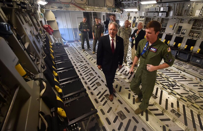 Charleston Mayor John Tecklenburg, left, tours a C-17 Globemaster III alongside Staff Sgt. Cody Skidmore, right, 15th Airlift Squadron loadmaster, as part of a site visit here, July 25. The locations Tecklenburg toured included the Naval Health Clinic Charleston, the Naval Nuclear Power Training Command and the 841st Transportation Battalion. Tecklenburg was selected to represent the installation at the Joint Civilian Orientation Conference in August 2017. The mission of JCOC is to increase public understanding of national defense by enabling American business and community leaders to directly observe and engage with the U.S. military. 