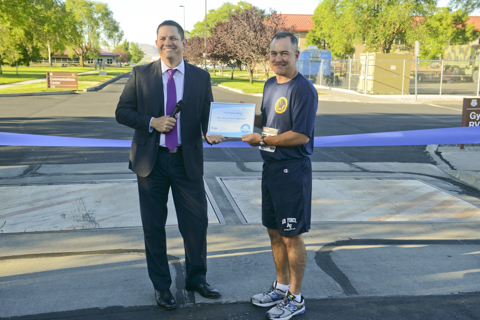 Klamath County Commissioner Derrick DeGroot presents a Blue Zones Project Approved Worksite certificate to Col. Jeff Smith, 173rd Fighter Wing commander, at the Blue Zones Project ribbon cutting ceremony and Sentry Eagle 5K run/walk July 20, 2017, at Kingsley Field in Klamath Falls, Ore. The ribbon cutting ceremony designated Kingsley Field as a Blue Zones Project Approved Worksite and was followed by the Sentry Eagle 5K run/walk. The Blue Zones Project encourages changes in communities that lead to healthier options. (U.S. Air National Guard photo by Staff Sgt. Riley Johnson)