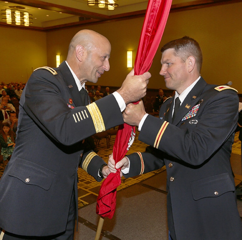Maj. Gen. Scott Spellmon passes the district colors to Col. John Hudson, officially charging him with the responsibility of the USACE Omaha District Commander. 