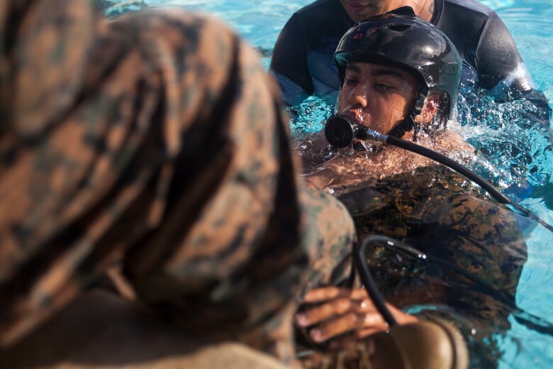 A U.S. Marine practices using an Emergency Breathing System during Shallow Water Egress Training, Marine Corps Base Hawaii, July 21, 2017. In the event of an Amphibious Assault Vehicle sinking, Submerged Vehicle Egress Training and Underwater Egress Training are vital training programs that prepares Marines and Sailors on safely escaping the vehicle. (U.S. Marine Corps photo by Lance Cpl. Matthew Kirk)