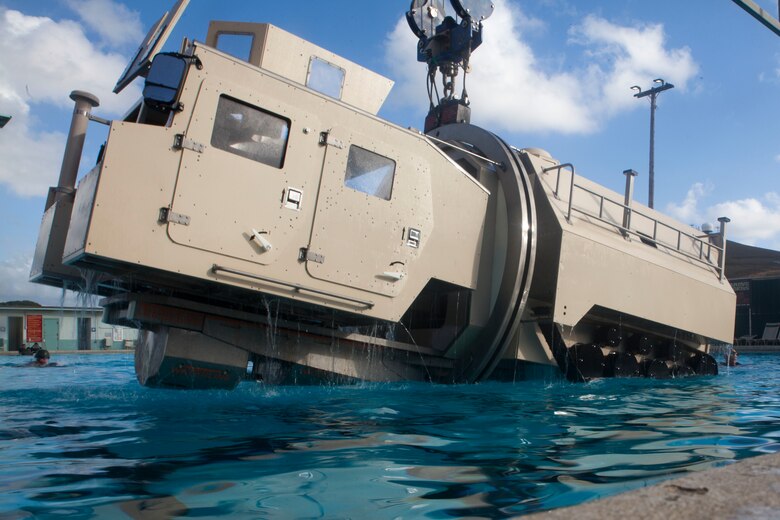 A Submerged Vehicle Egress Trainer (SVET) submerges into water during Underwater Egress Training (UET), Marine Corps Base Hawaii, July 21, 2017. In the event of an Amphibious Assault Vehicle sinking, SVET and UET are vital training programs that prepares Marines and Sailors on safely escaping the vehicle. (U.S. Marine Corps photo by Lance Cpl. Matthew Kirk)