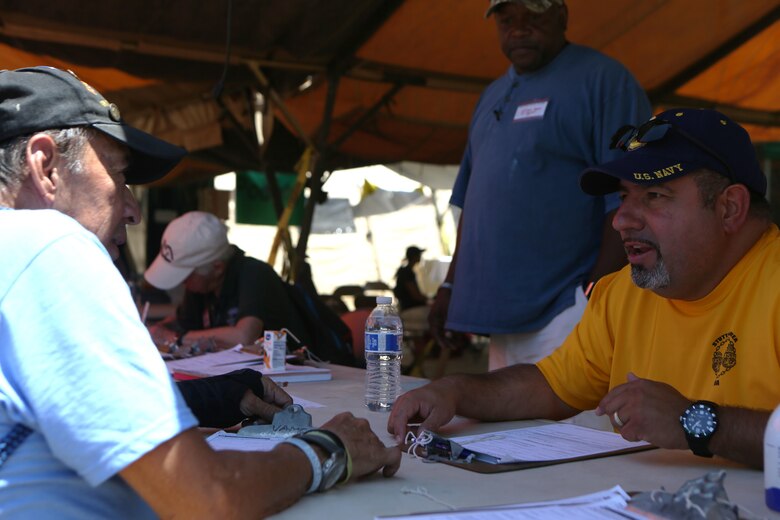 Luis Patino, right, a Navy veteran and volunteer with the Veterans Village of San Diego (VVSD), assists a veteran who is receiving medical care during the 30th Annual Homeless Veteran Stand Down at San Diego High School in San Diego, July 21. VVSD hosted the event July 19 to 21 to support San Diego’s homeless veterans by providing services such as medical and dental care, legal assistance, hygiene services, food and shelter during the stand down. (U.S. Marine Corps photo by Cpl. Daniel Auvert/Released)