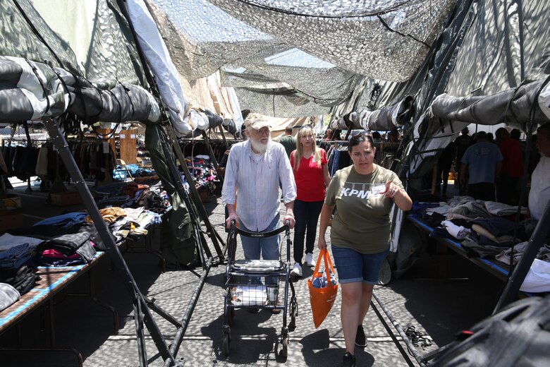 Two volunteers with the Veterans Village of San Diego help a veteran select clothes during the 30th Annual Homeless Veteran Stand Down at San Diego High School in San Diego, July 21. VVSD hosted the event July 19 to 21 to support San Diego’s homeless veterans by providing services such as medical and dental care, legal assistance, hygiene services, food and shelter during the stand down. (U.S. Marine Corps photo by Lance Cpl. Jake McClung/Released)