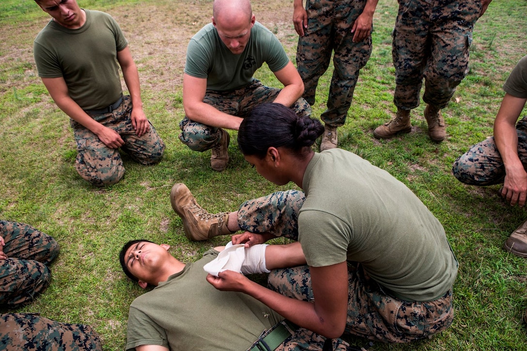 CAMP PENDLETON, Calif. – U.S. Marine Lance Cpl. Vella Jackson, a food service specialist with Food Service Company, Headquarters Regiment, 1st Marine Logistics Group, dresses a wound with gauze during the practical application portion of a combat lifesaver course July 22, 2017. The CLS course provides Marines with experience in a realistic, high stress environment, as well as instructional knowledge and techniques necessary to provide effective combat lifesaving training for medical personnel and selective Marines. (U.S. Marine Corps Photo by Lance Cpl. Joseph Sorci)