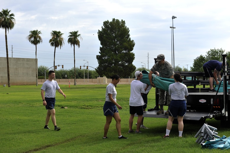 Thunderbolts begin to unload the Back-to-School Bash canopys July 25, 2017 at Luke Air Force Base, Ariz. The event gives away school supplies to first time students up to high schoolers.