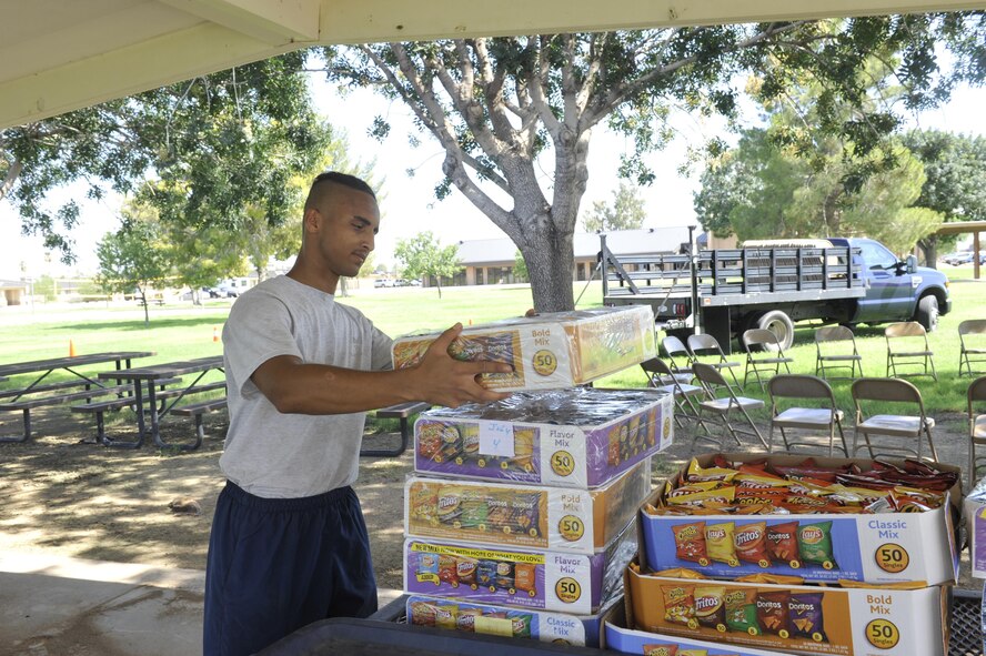 Airman 1st Class Archilious Green, 56th Component Maintenance Squadron fuels systems journeyman, stacks boxes of chips for the Back-to-School Bash July26, 2017 at Luke Air Force Base, Ariz. The event is being held from 5:30 p.m. until 8:00 p.m.
