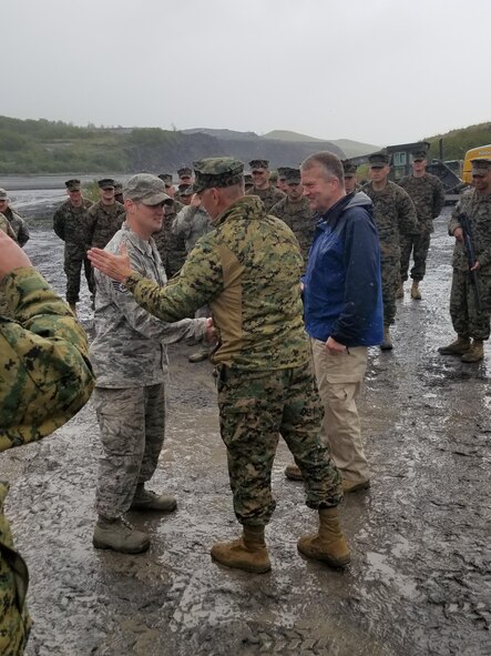 U.S. Air Force Staff Sgt. John Lee, a 354th Civil Engineer Squadron (CES) structural craftsman receives a coin from U.S. Marine Corps (USMC) Lt. Gen. Rex C. McMillan, the USMC Forces Reserve and Marine Forces Northern Command commander, June 10, 2017, during Innovative Readiness Training in Old Harbor, Alaska. Members of the 354th CES were there to trained members of other services and helped expand a runway. (Courtesy photo)