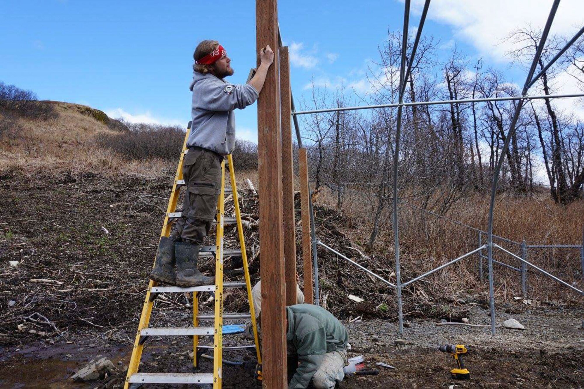 U.S. Air Force Airmen assigned to the 354th Civil Engineer Squadron (CES) work with a local engineer to build a greenhouse in Old Harbor, Alaska. The 354th CES Airmen completed multiple projects in the town, which helped improve the community’s quality of life. (Courtesy photo)