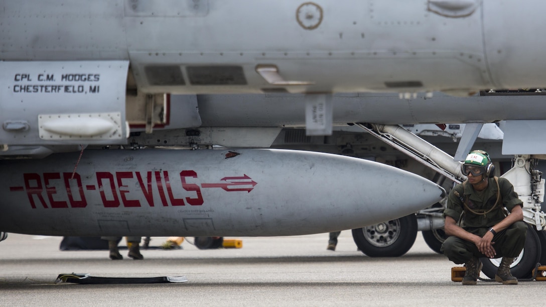 U.S. Marine Corps Lance Cpl. Xavier Diaz, an airframes mechanic with Marine Fighter Attack Squadron (VMFA) 232, waits before refilling the reservoirs of an F/A-18C Hornet at Japan Air Self-Defense Force (JASDF) Hyakuri Air Base, Japan, July 12, 2017. VMFA-232 has been conducting exercises with the JASDF as part of the Aviation Training Relocation program, which is designed to increase operational readiness and interoperability between U.S. and Japanese forces. The squadron plans to enhance proficiency in dissimilar basic fighter section engaged maneuvers, active air defense and air interdictions, as well as conduct fighter attack instructor work-ups, and weapons and tactics instructor prerequisites. (U.S. Marine Corps photo by Lance Cpl. Mason Roy)