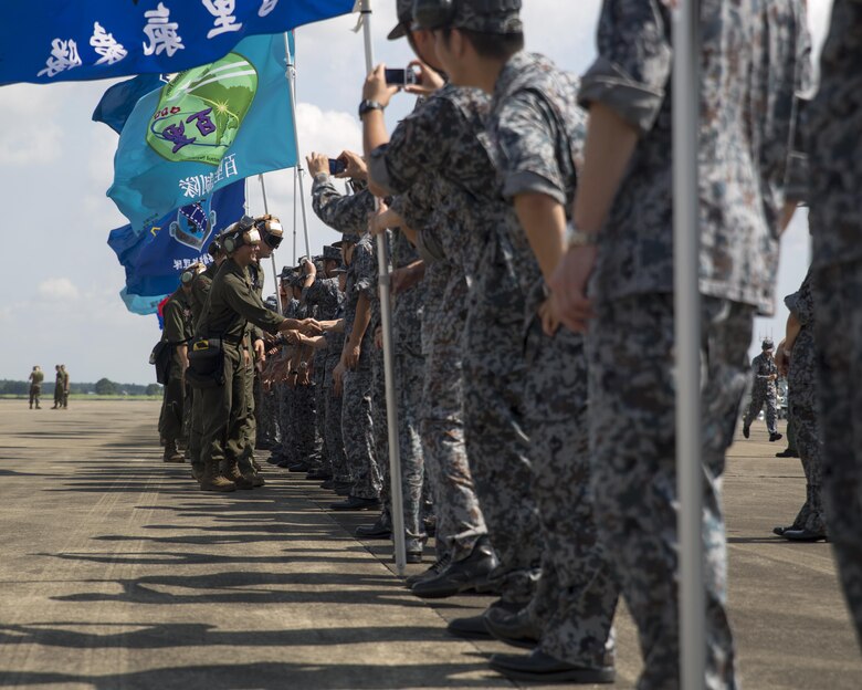 U.S. Marines with Marine Fighter Attack Squadron (VMFA) 232, say farewell to Japan Air Self-Defense Force (JASDF) service members at JASDF Hyakuri Air Base, Japan, July 24, 2017. VMFA-232 conducted exercises with the JASDF as part of the Aviation Training Relocation program, which is designed to increase operational readiness and interoperability between U.S. and Japanese forces, and to reduce the overall noise impact across Japan by dispersing bilateral jet-fighter training of U.S. forces across a multitude of different JASDF bases. (U.S. Marine Corps photo by Lance Cpl. Mason Roy)