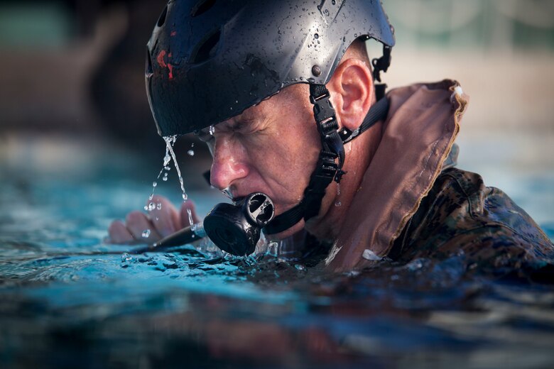 Col. Michael Styskal, the commanding officer of 3rd Marine Regiment, 3rd Marine Division, practices using an Emergency Breathing System during Shallow Water Egress Training, Marine Corps Base Hawaii, July 21, 2017. In the event of an Amphibious Assault Vehicle sinking, Submerged Vehicle Egress Training and Underwater Egress Training are vital training programs that prepares Marines and Sailors on safely escaping the vehicle. (U.S. Marine Corps photo by Lance Cpl. Matthew Kirk)
