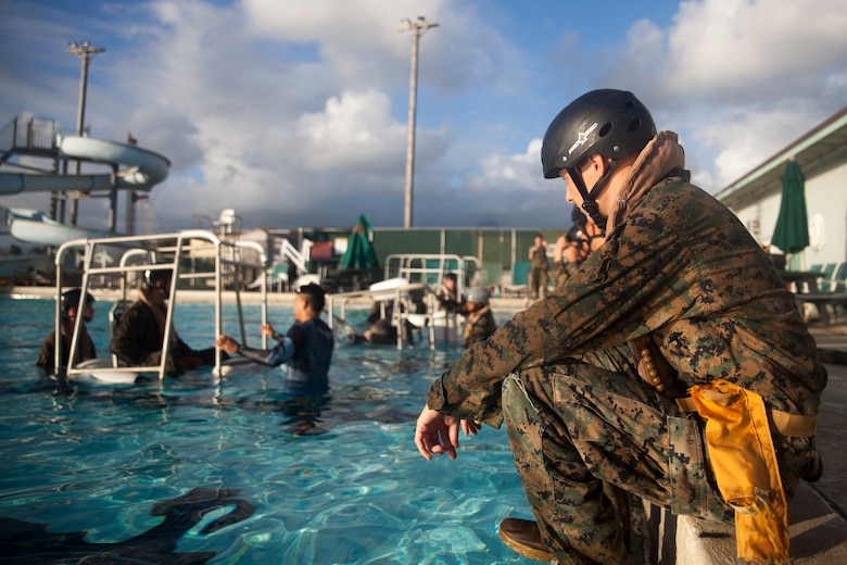 Lance Cpl. Justin Collins, a grenadier with 3rd Marine Regiment, 3rd Marine Division, waits to complete the Shallow Water Egress Training at the base pool aboard Marine Corps Base Hawaii, July 21, 2017. In the event of an Amphibious Assault Vehicle sinking, Submerged Vehicle Egress Training and Underwater Egress Training are vital training programs that prepares Marines and Sailors on safely escaping the vehicle. (U.S. Marine Corps photo by Lance Cpl. Matthew Kirk)