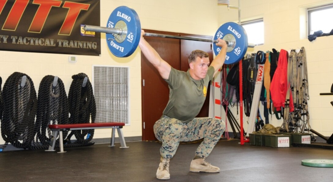 Sgt. Justin Odom, Marine Corps Systems Command training non-commissioned officer, performs a snatch lift July 18, at the High Intensity Tactical Training facility aboard Marine Corps Base Quantico, Virginia. After earning the top male competitor spot in the HITT preliminaries at Quantico, Odom was selected to represent the base in the Third Annual HITT Athlete Championship at Camp Pendleton, California, in August. (U.S. Marine Corps photo by Kaitlin Kelly)