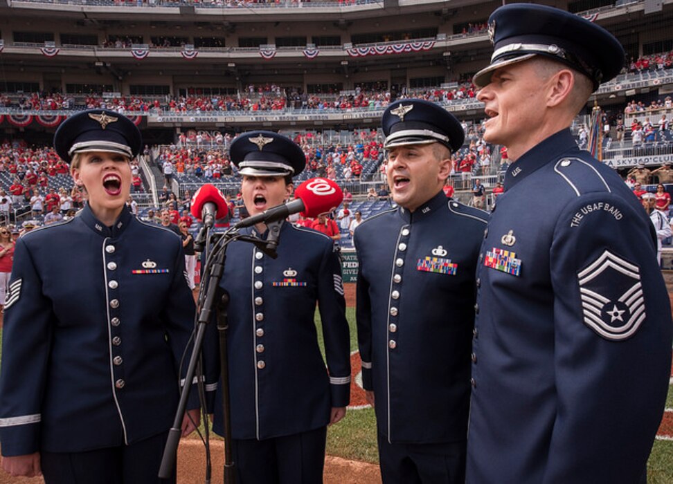 Members of the United States Air Force Band's Singing Sergeants perform the National Anthem before a home game at the Washington Nationals Park July 4, 2017, Washington, D.C.
