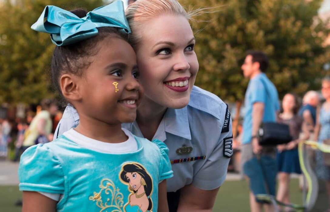 This past Sunday, the Concert Band and Singing Sergeants performed a concert at the National Harbor entitled The Kid in All of Us. Here is TSgt Ashley Keeks with a new fan. (U.S. Air Force photos/MSgt Brandon Chaney/released)